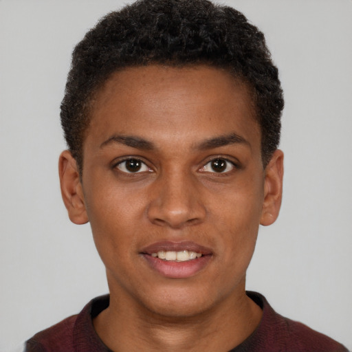 Joyful black young-adult male with short  brown hair and brown eyes