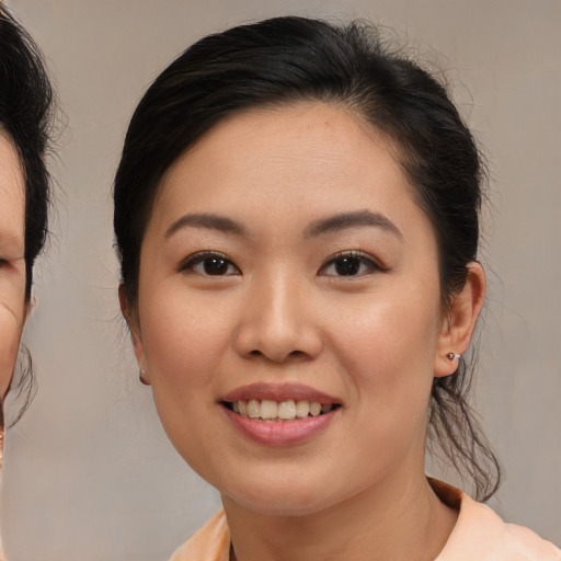 Joyful asian young-adult female with medium  brown hair and brown eyes