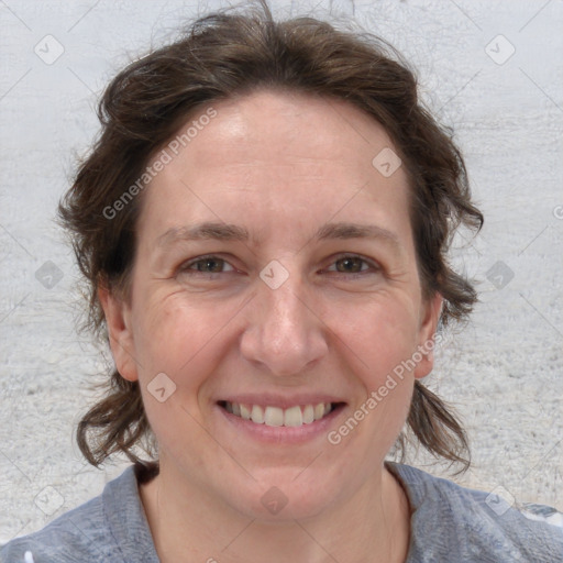 Joyful white adult female with medium  brown hair and blue eyes