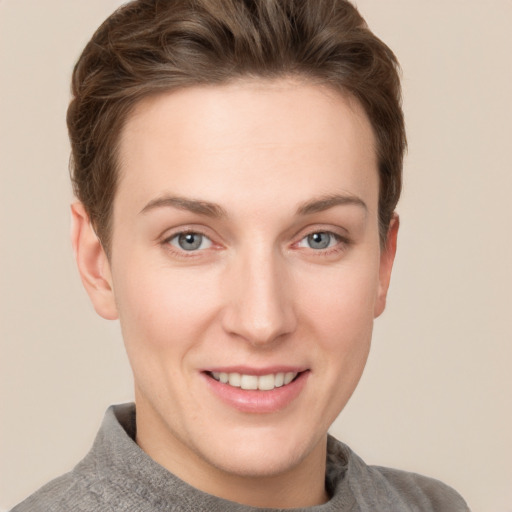 Joyful white young-adult female with short  brown hair and grey eyes