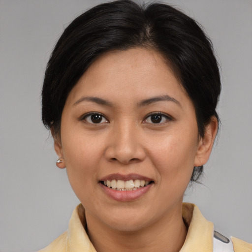 Joyful asian young-adult female with medium  brown hair and brown eyes