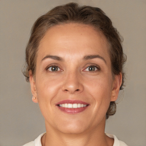 Joyful white adult female with short  brown hair and brown eyes