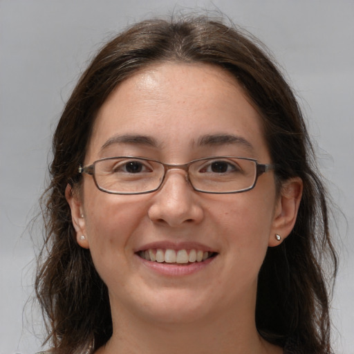 Joyful white adult female with medium  brown hair and grey eyes