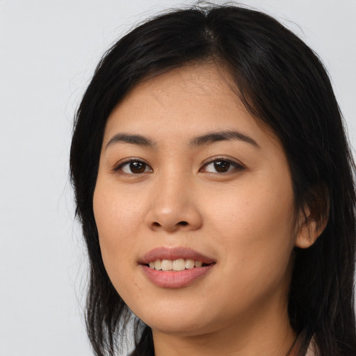 Joyful asian young-adult female with long  black hair and brown eyes