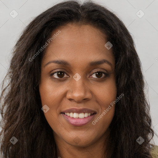 Joyful black young-adult female with long  brown hair and brown eyes