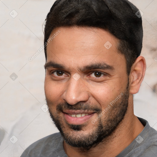 Joyful white adult male with short  black hair and brown eyes