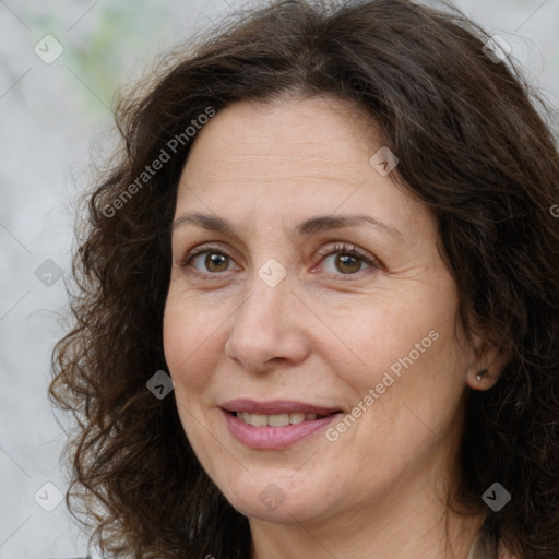 Joyful white adult female with long  brown hair and brown eyes