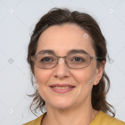 Joyful white adult female with medium  brown hair and brown eyes