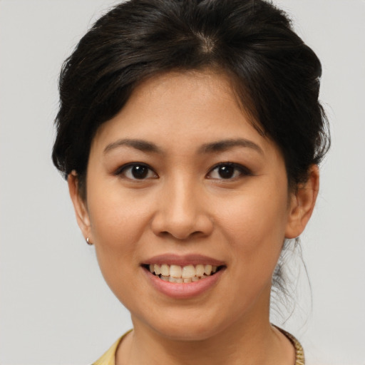 Joyful asian young-adult female with short  brown hair and brown eyes