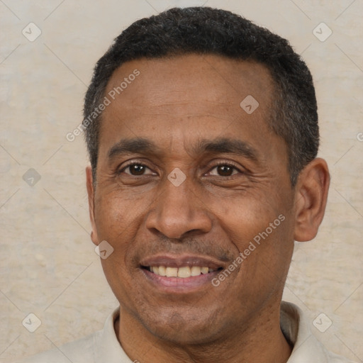 Joyful black adult male with short  black hair and brown eyes