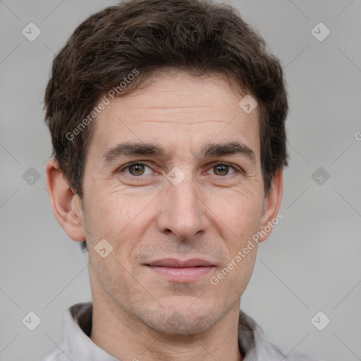 Joyful white adult male with short  brown hair and brown eyes