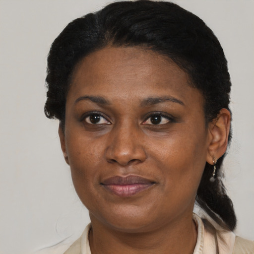 Joyful black adult female with short  black hair and brown eyes