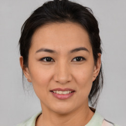 Joyful asian young-adult female with medium  brown hair and brown eyes