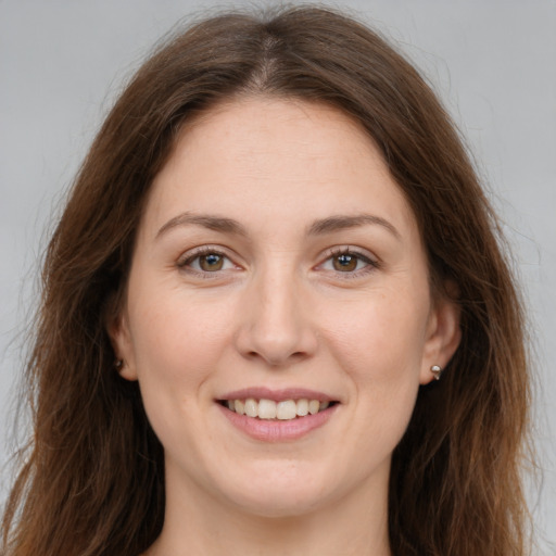 Joyful white young-adult female with long  brown hair and brown eyes