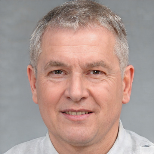 Joyful white middle-aged male with short  gray hair and brown eyes