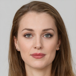 Joyful white young-adult female with long  brown hair and grey eyes