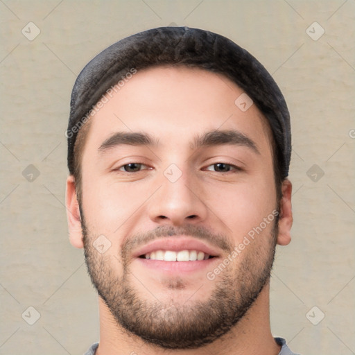 Joyful white young-adult male with short  black hair and brown eyes