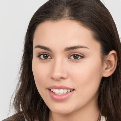 Joyful white young-adult female with long  brown hair and brown eyes