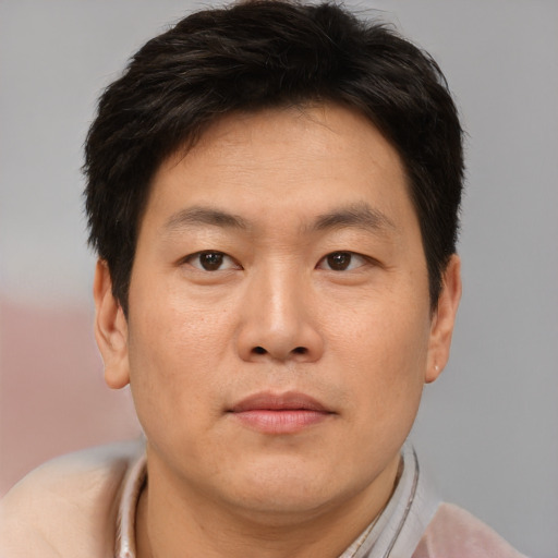 Neutral asian adult male with short  brown hair and brown eyes