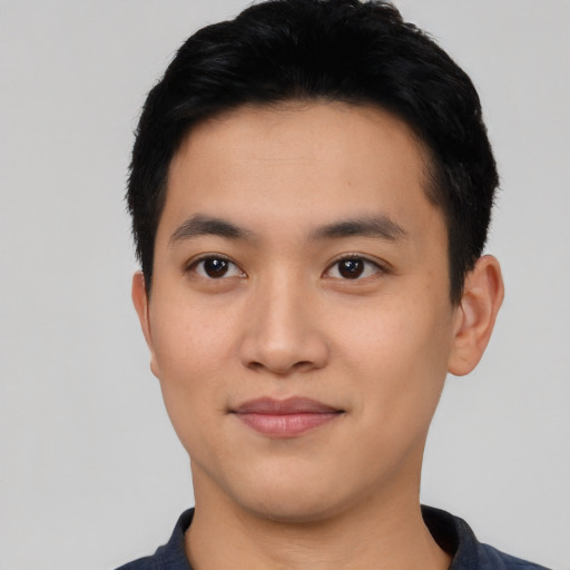 Joyful asian young-adult male with short  black hair and brown eyes