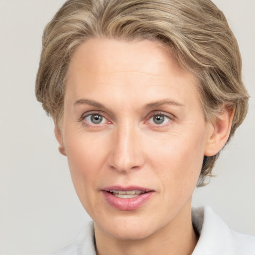 Joyful white adult female with medium  brown hair and grey eyes