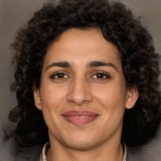 Joyful latino adult female with short  brown hair and brown eyes