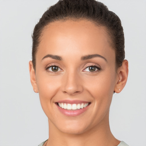 Joyful white young-adult female with short  brown hair and brown eyes