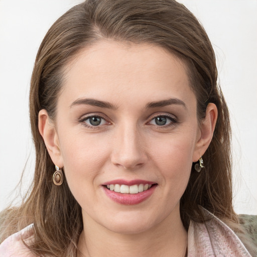 Joyful white young-adult female with medium  brown hair and grey eyes