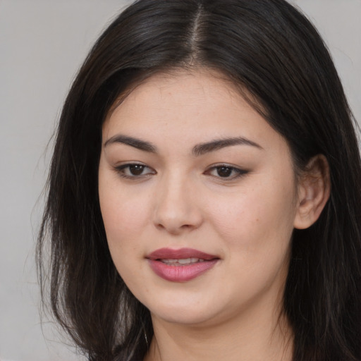 Joyful asian young-adult female with long  brown hair and brown eyes