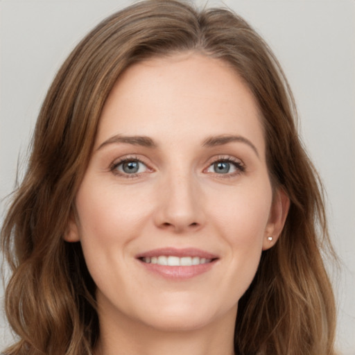 Joyful white young-adult female with long  brown hair and green eyes