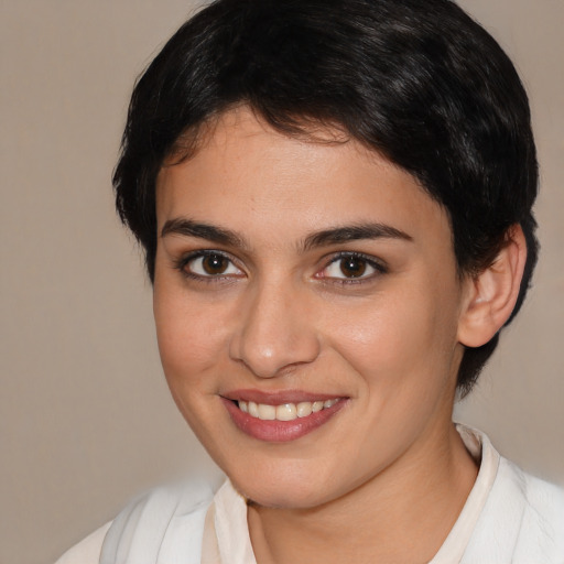 Joyful white young-adult female with short  brown hair and brown eyes