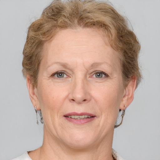 Joyful white middle-aged female with short  brown hair and grey eyes