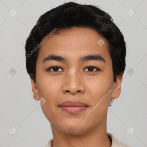 Joyful latino young-adult male with short  black hair and brown eyes