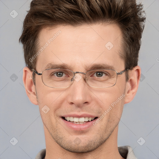 Joyful white adult male with short  brown hair and grey eyes