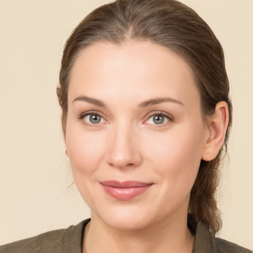 Joyful white young-adult female with medium  brown hair and brown eyes