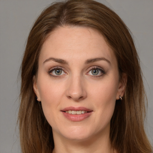 Joyful white young-adult female with long  brown hair and green eyes