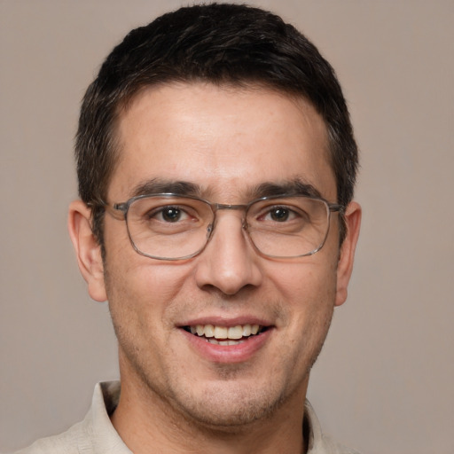 Joyful white adult male with short  brown hair and brown eyes