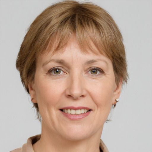 Joyful white adult female with medium  brown hair and grey eyes