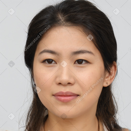 Joyful asian young-adult female with long  brown hair and brown eyes