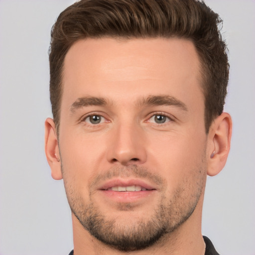 Joyful white young-adult male with short  brown hair and brown eyes