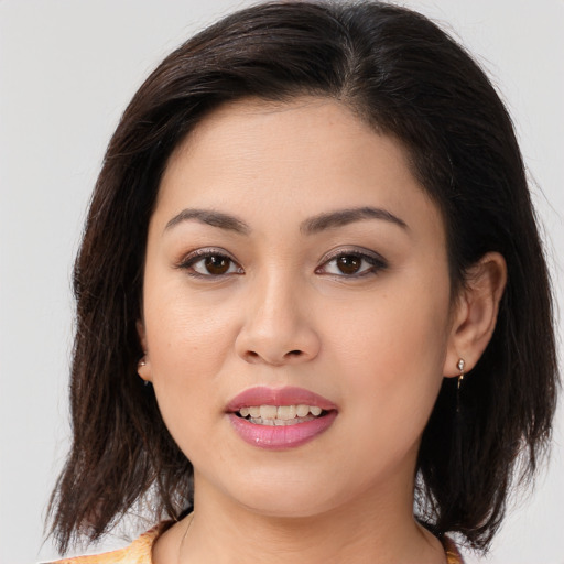 Joyful white young-adult female with medium  brown hair and brown eyes