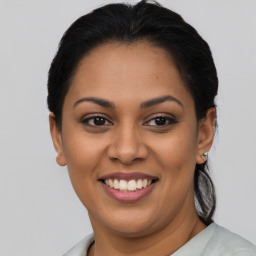 Joyful latino young-adult female with short  brown hair and brown eyes