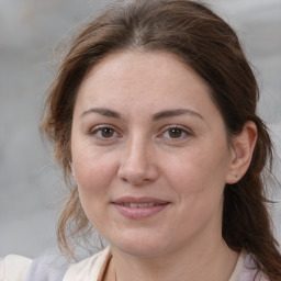 Joyful white adult female with medium  brown hair and brown eyes