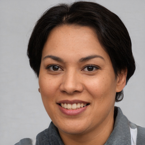 Joyful asian young-adult female with short  brown hair and brown eyes
