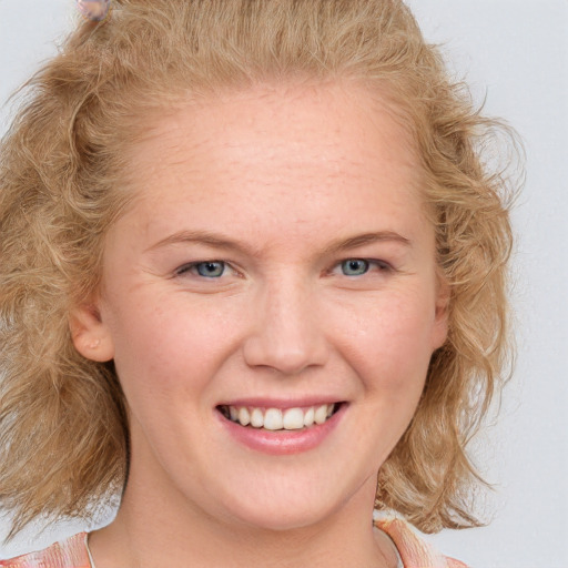 Joyful white young-adult female with medium  brown hair and blue eyes