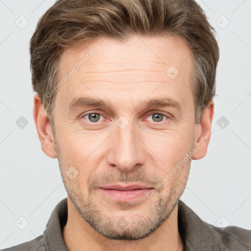 Joyful white adult male with short  brown hair and grey eyes