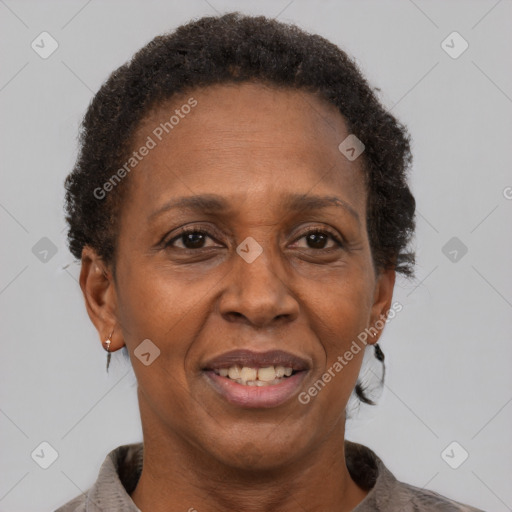 Joyful black adult female with short  brown hair and brown eyes