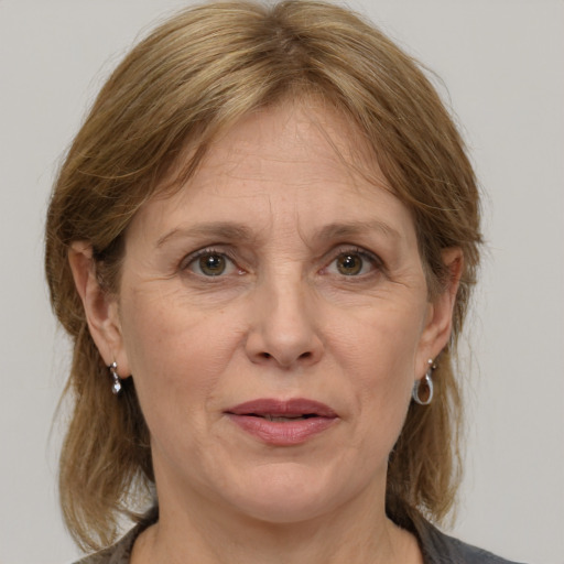 Joyful white adult female with medium  brown hair and grey eyes