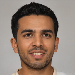 Joyful latino young-adult male with short  black hair and brown eyes