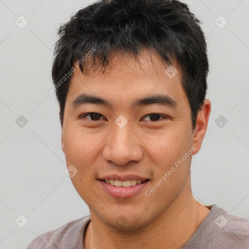 Joyful asian young-adult male with short  black hair and brown eyes